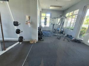 a room with a gym with weights and treadmills at Near Islaverde Beach home Carolina Puerto Rico. in Carolina