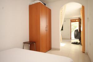 a bedroom with a bed and a wooden cabinet at Apartments with a parking space Rukavac, Vis - 2444 in Rukavac