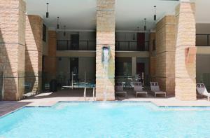 a large swimming pool in a building with columns at Walk Score 81-Shopping District-King Bed-Parking - G4004 in Scottsdale