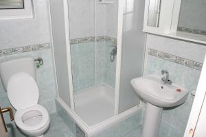 y baño con ducha, aseo y lavamanos. en Apartments by the sea Podgora, Makarska - 2624, en Podgora