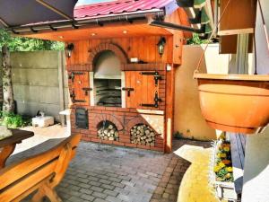 a outdoor kitchen with a pizza oven in a patio at Wooden House by Ostrowieckie Lake with Beach in Kosierzewo