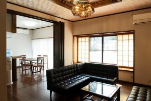 a living room with a couch and a table at SABAE MEGANE HOUSE- Vacation STAY 5077 in Sabae