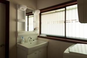 a white bathroom with a sink and a window at SABAE MEGANE HOUSE- Vacation STAY 5077 in Sabae