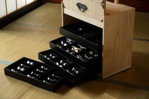 a wine cellar with three shelves of wine bottles at SABAE MEGANE HOUSE- Vacation STAY 5077 in Sabae