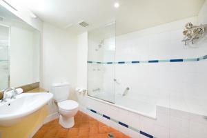 a bathroom with a toilet and a sink and a shower at 'Top Horizons' Resort style Stay with Pool & Ocean Views in Darwin