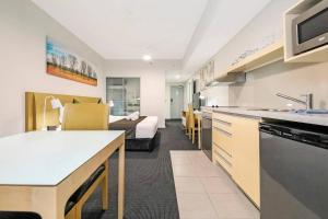 A kitchen or kitchenette at '18th in the Clouds' CBD Resort Living with Pool