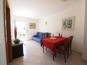 a dining room with a table and a blue couch at Apartments and rooms by the sea Slano, Dubrovnik - 2682 in Slano