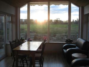 a living room with a table and a large window at Riverside Glanworth in Glanworth