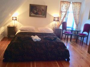 a bedroom with a bed with two towels on it at Historical holiday home in Mielenko 400 m from the sea in Mielenko