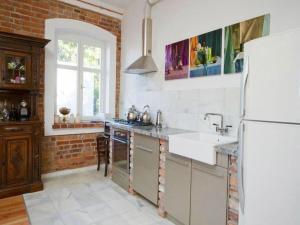 a kitchen with a white refrigerator and a sink at Historical holiday home in Mielenko 400 m from the sea in Mielenko