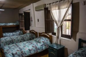 a room with two beds and a window at LA PACHAMAMA in San Juan