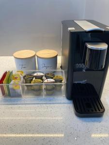 a coffee maker with a tray of cupcakes at Mountain Mist Apartments in Bright