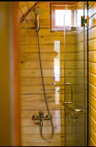 a bathroom with a shower with a glass door at Tanyoli Resort in Phan Rang
