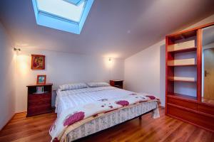 a bedroom with a bed and a skylight at Apartments by the sea Komiza, Vis - 2450 in Komiža