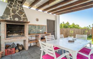 een patio met een tafel en een open haard bij Lovely Home In Nerja With House A Panoramic View in Nerja