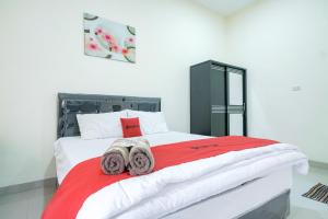 a bedroom with a bed with towels on it at RedDoorz @ Jalan Urip Sumoharjo Lampung in Kedaton