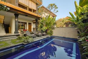 a pool in the backyard of a house at Gora House Bali in Ubud