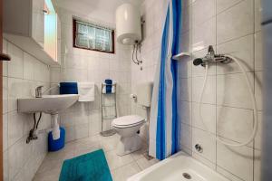 a bathroom with a sink and a toilet and a shower at Apartments by the sea Komiza, Vis - 2447 in Komiža