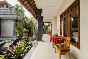 a dining room with a red table and chairs at Gora House Bali in Ubud