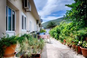 a garden with a table and chairs and potted plants at Apartments by the sea Vis - 2453 in Vis