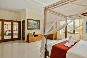 Postel nebo postele na pokoji v ubytování Gora House Bali