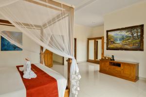 Postel nebo postele na pokoji v ubytování Gora House Bali