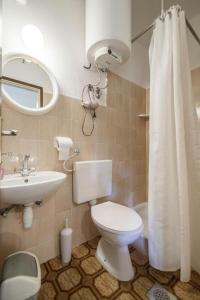 een badkamer met een toilet, een wastafel en een spiegel bij Apartments with WiFi Komiza, Vis - 2420 in Komiža