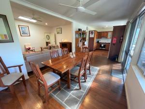 a dining room and living room with a table and chairs at Elizabeth Beach Guest House in Elizabeth Beach