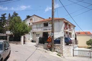 a house on the corner of a street at Apartments and rooms with parking space Mali Losinj (Losinj) - 2486 in Mali Lošinj