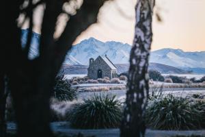 an image of a church with mountains in the background at Aldourie Lodge in Lake Tekapo