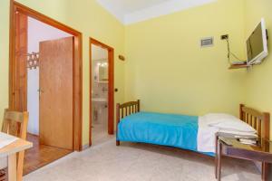 a bedroom with a bed and a desk and a television at Apartments by the sea Mali Losinj (Losinj) - 2489 in Mali Lošinj