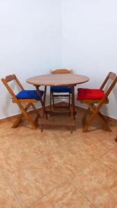 a wooden table with two chairs and a table with at Rent apartament Rio de Janeiro Copacabana in Rio de Janeiro