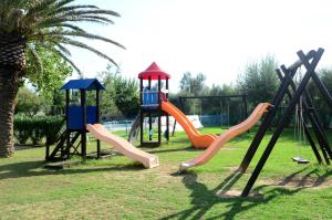 a group of playground equipment in a park at Villaggio Diomedea in Campomarino