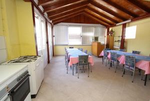 a dining room with a long table and chairs at Double Room Podaca 2613a in Podaca