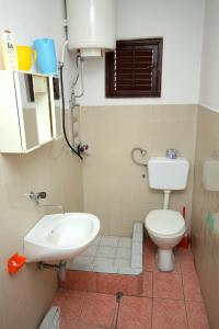 a bathroom with a toilet and a sink at Twin Room Podaca 2613d in Podaca