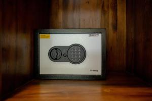 a microwave with a remote control on the side of it at Gora House Bali in Ubud