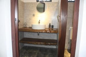 a bathroom with a sink and a mirror at Perle de Riambel in Riambel