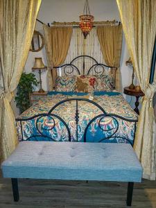 a bedroom with a blue bed with curtains and a bedskirtspectspectspectspects at RnR Beach House: 1 mi to Ocean,Pier, Harbor, Beach in Oceanside