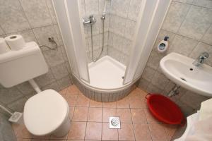 a bathroom with a shower and a toilet and a sink at Apartments by the sea Promajna, Makarska - 2673 in Promajna