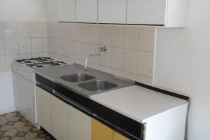 a kitchen with a sink and a stove at Apartments and rooms by the sea Zaostrog, Makarska - 2662 in Zaostrog