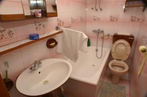 a pink bathroom with a sink and a toilet at Apartments by the sea Zivogosce - Mala Duba, Makarska - 2603 in Igrane