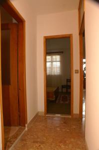 a hallway with a door and a mirror in a room at Apartments by the sea Zivogosce - Mala Duba, Makarska - 2603 in Igrane