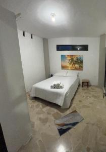A bed or beds in a room at Acogedor, amplio a 5 min de Las Palmas-Esmeraldas