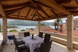 a table and chairs on a patio with a view at Apartments and rooms by the sea Slano, Dubrovnik - 2687 in Slano