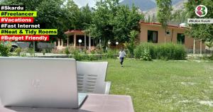 laptopa siedzącego na stole na dziedzińcu w obiekcie Mulberry Continental Hotel Skardu w mieście Skardu