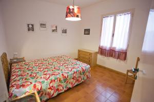 a bedroom with a bed and a dresser and a window at Villino Le Sughere in Marciana