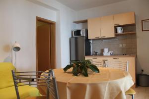 a kitchen with a table with a plant on it at Apartment Zaostrog 2625a in Zaostrog
