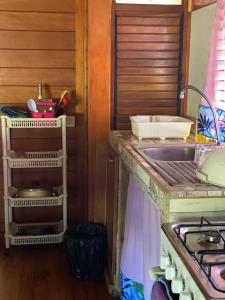 a kitchen with a sink, stove, and cabinets at Vaiotaha Lodge in Bora Bora
