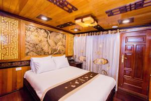 a bedroom with a bed on a boat at Victory Cruise in Ha Long