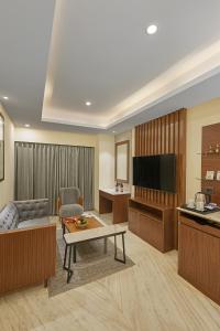 a living room with a couch and a flat screen tv at Southern Star,Bangalore in Bangalore